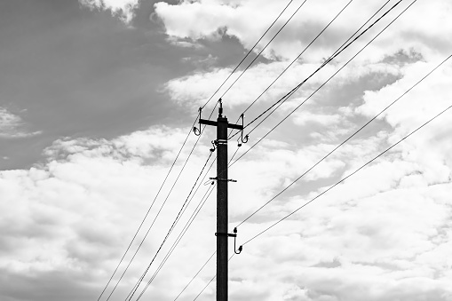Power electric pole with line wire on dark background close up, photography consisting of power electric pole with line wire under sky, line wire in power electric pole for residential buildings