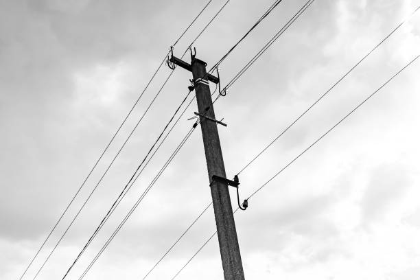 istock Power electric pole with line wire on dark background close up 1630998503