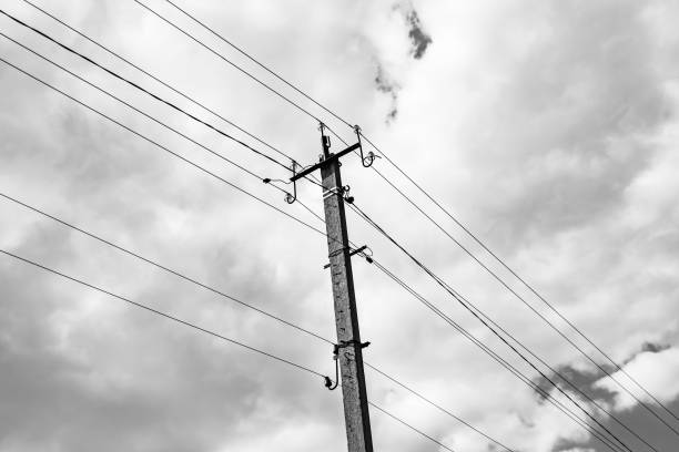 istock Power electric pole with line wire on dark background close up 1630999587