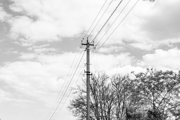 istock Power electric pole with line wire on dark background close up 1631002831