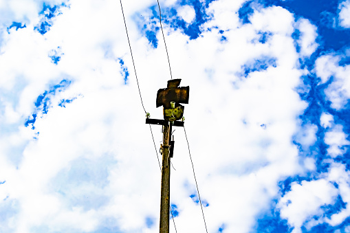 Power electric pole with line wire on colored background close up, photography consisting of power electric pole with line wire under sky, line wire in power electric pole for residential buildings