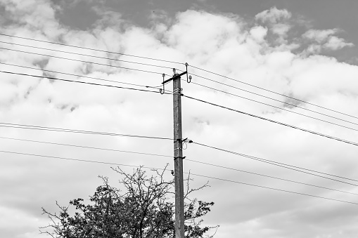 Power electric pole with line wire on dark background close up, photography consisting of power electric pole with line wire under sky, line wire in power electric pole for residential buildings