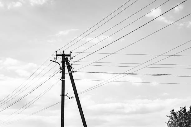istock Power electric pole with line wire on dark background close up 1631005110