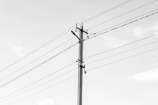 istock Power electric pole with line wire on dark background close up 1631005650
