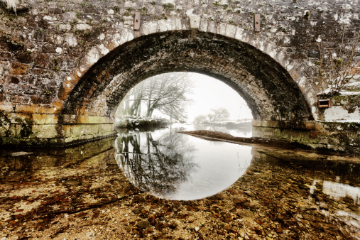 A winter view through a stone bridge at Two Bridges, Dartmoor, Devon, UK