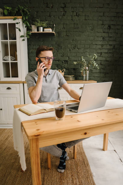istock Trader talk on phone, investor broker analyze indexes. Serious man working, learning on laptop in home office. Freelance. Communication. Trading online investment data on stock market, cryptocurrency. 1631012746