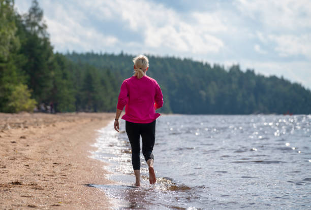 istock Woman jogging on the beach 1631014169