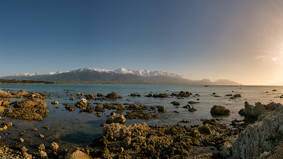 Coastal sunrise at Kaikoura with the snow covered mountains in the background