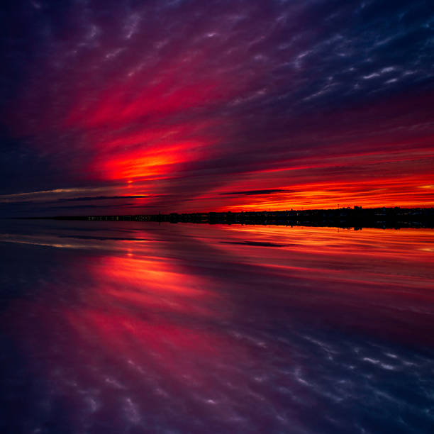 Summerside Harbour Sunset Seascape at twilight hour with white cumulus clouds reflected on the water on Gulf of St Lawrence, Prince Edward Island, Canada