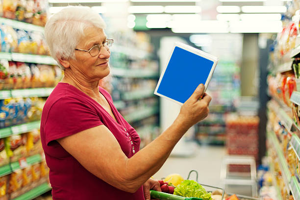 istock Senior woman reading description on the box 163107477
