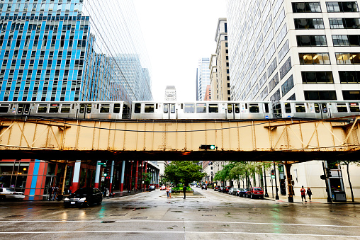 'L' elevated train crossing La Salle street, between urban buildings of Chicago, Illinois, USA.