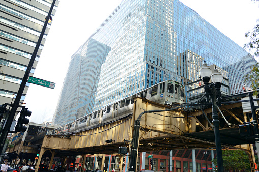 'L' elevated train crossing La Salle street, between urban buildings of Chicago, Illinois, USA.