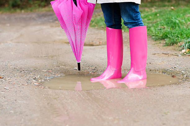 istock Young woman standing in puddle 163107880