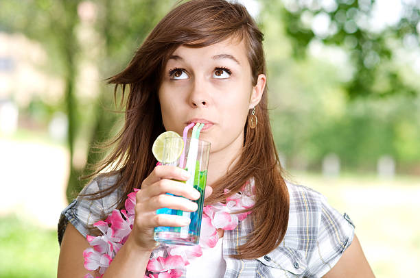 istock Young woman drinking blue curacao cocktail 163107940