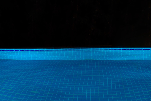 The swimming pool at night without people.