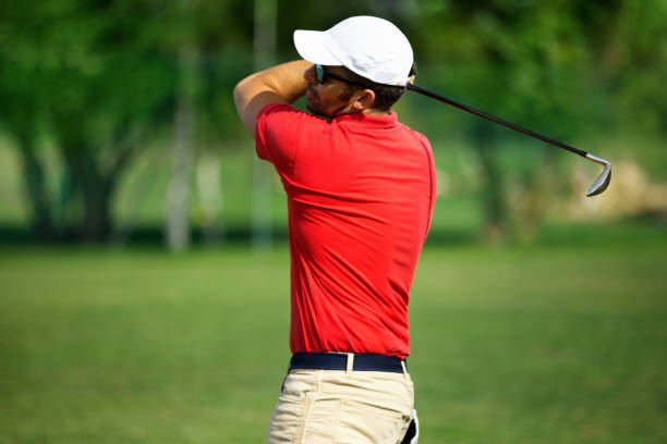 istock Young man taking a long putt at a golf course. 1631100931