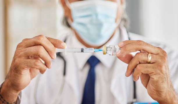 Medical, vaccination and hands of doctor with a needle for a flu, cold or allergy treatment. Professional, injection vial and closeup of healthcare worker with smallpox vaccine syringe in clinic. Medical, vaccination and closeup of a doctor with a needle for a flu, cold or allergy treatment. Professional, injection vial and zoom of male healthcare worker with a vaccine syringe in a clinic. antiviral drug stock pictures, royalty-free photos & images