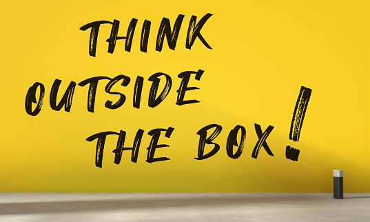 Think Outside The Box Written Yellow Wall. Idea And Message Concept.