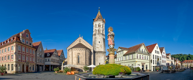 Panoramic view of the market square in the historic old town of Schwäbisch Gmünd with patrician houses, St. John's Church and street cafes in sunny weather and cloudless sky