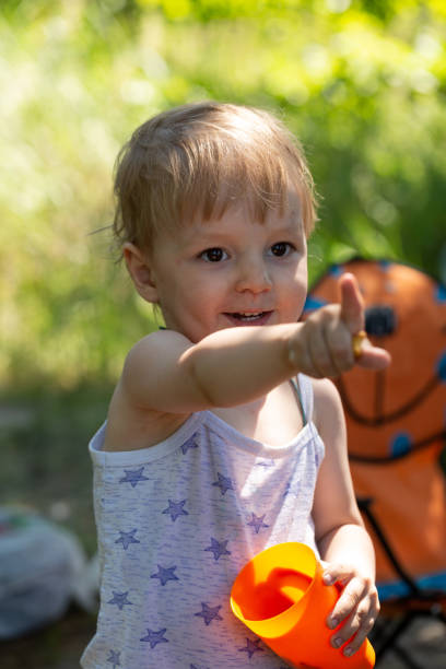 istock A dirty little boy points his finger forward and smiles 1631143142