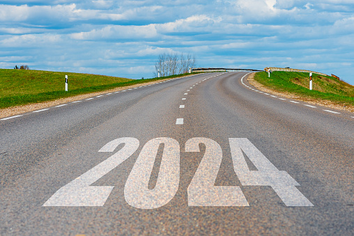 An empty road path end and new year 2024. Upcoming 2024 goals and leaving behind 2023 year. passing time future, life plan change, work start run line, sunset hope growth begin, go forward concept.