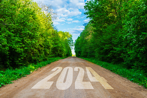 2024 written on of empty journey road and beautiful blue sky,and forest. Concept for vision 2024 travel concept.