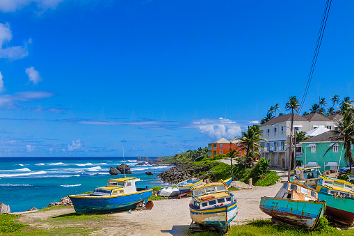 Colorful boats under repair at Tent Bay, a picturesque bay on the east coast of Barbados, facing the Atlantic Ocean.