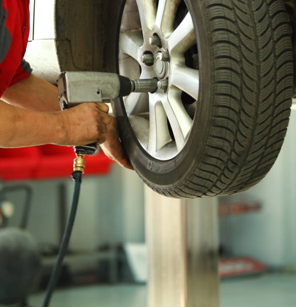 istock Car mechanic replacing a wheel. 163116760