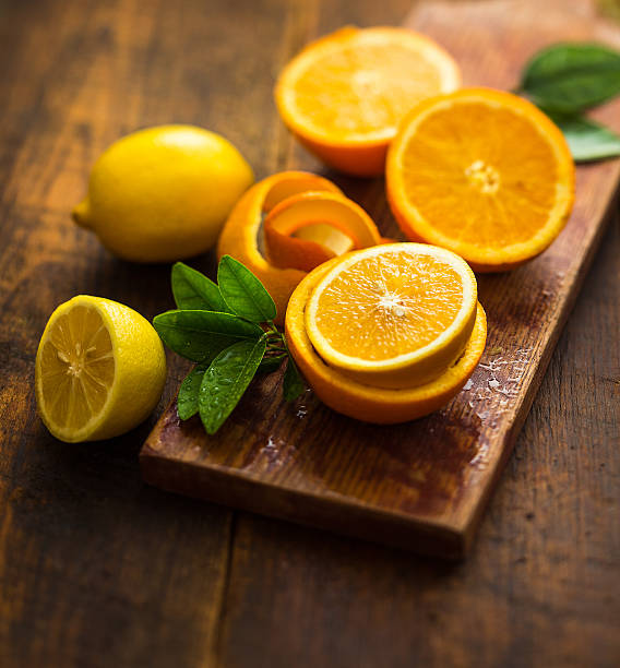 citrus oranges and lemons over a wooden background citrus fruit stock pictures, royalty-free photos & images