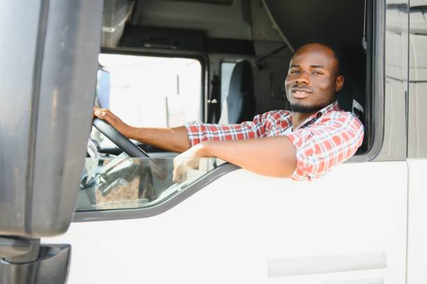istock Courier Delivery. Black Man Driver Driving Delivery Car 1631215736