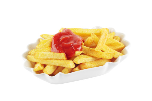Bowl with french fries topped with ketchup, isolated on a white background.
