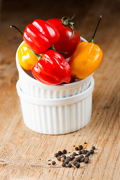 Red chili habanero peppers on old wooden table