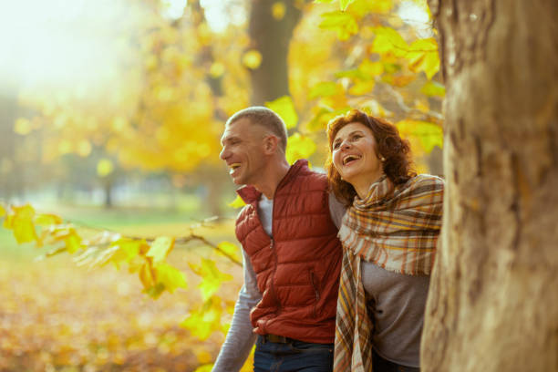 istock smiling stylish couple in park near tree 1631232484