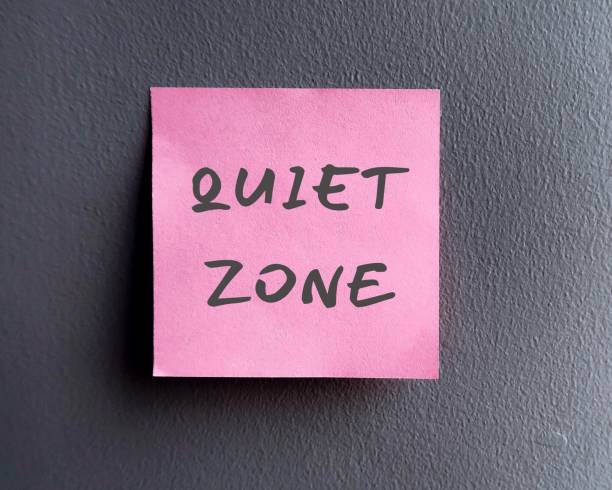 istock Wall with pink note written QUIET ZONE, means controlling noise and improving privacy to focus on study like workplace library, hospital or meditation area where mobile phones are banned 1631254037