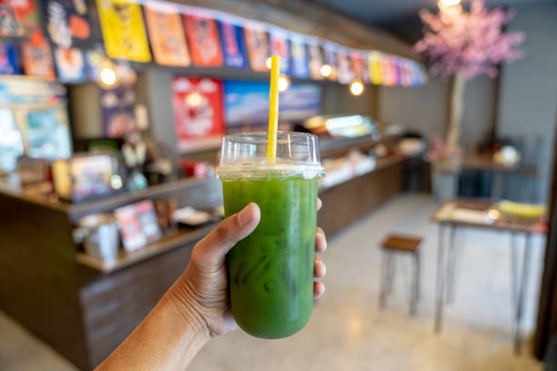 istock Hand holding refreshing green tea with Japanese restaurant background. 1631262425