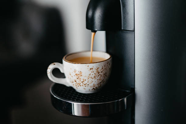 istock Preparing espresso with a coffee machine. Process of pouring coffee at cup. Cup of coffee close-up. Nice morning routine at hom 1631281987