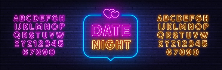 Date Night neon lettering in the speech bubble on brick wall background. Yellow and blue neon alphabets.