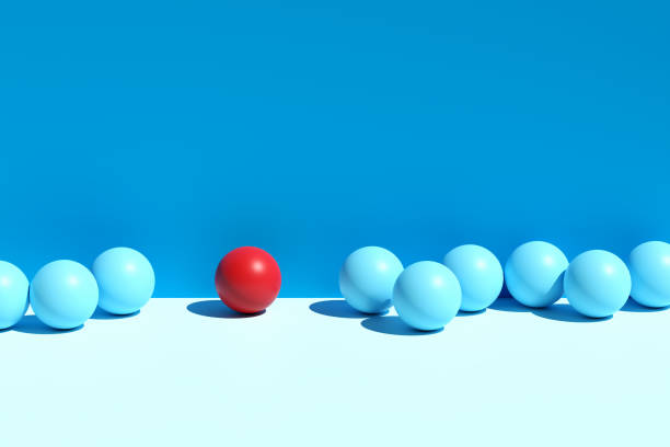 istock Difference and individuality. Red sphere stands out from the blue spheres. 1631300600