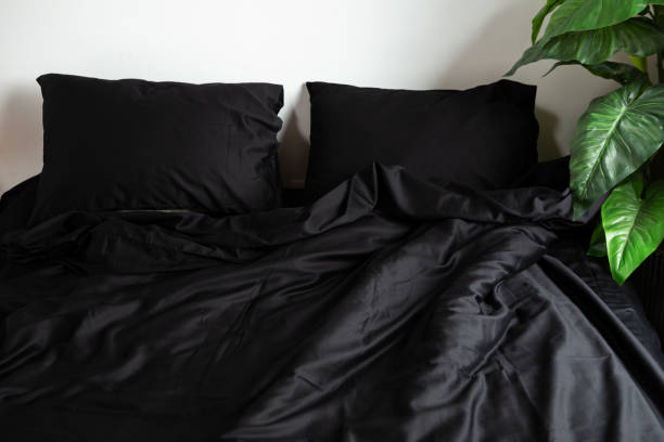 istock Black satin bed clothes white wall two pillow 1631324752