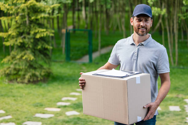 istock Postman carrying package and documents outdoors. 1631347789