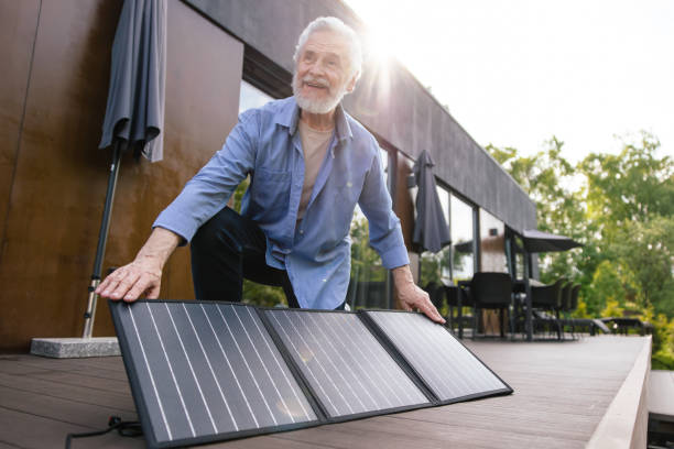 istock Caucasian man with solar panel innovation technology alternative energy. 1631348344