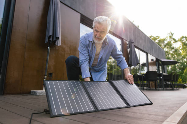 istock Caucasian man with solar panel innovation technology alternative energy. 1631348357