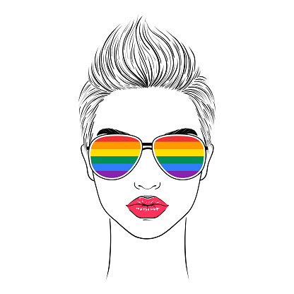 Woman wearing glasses with lgbt community flag.
