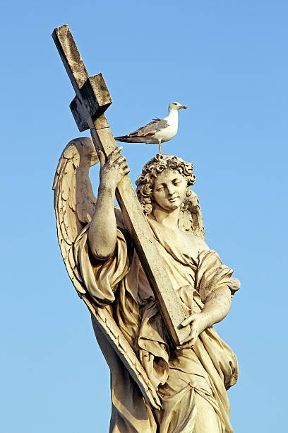 istock Angel marble statue in Rome, with cross and seagull 163136209