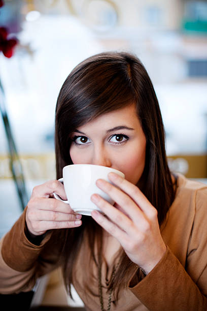 istock Close up of woman drinking coffee 163136322