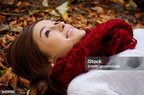 Beauty Girl Lying Down On Leaves Stock Photo - Download Image Now - Adult, Autumn, Beautiful People