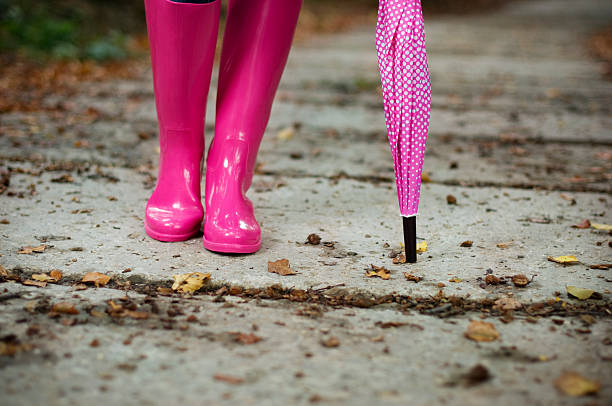 istock Woman with umbrella wearing rubber boots 163136571