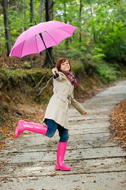 istock Cute young woman having fun after raining 163136600