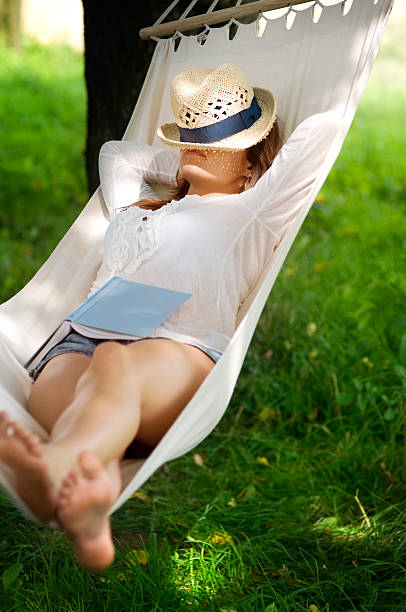 Sleeping on hammock Relaxing on hammock hammock relaxation women front or back yard stock pictures, royalty-free photos & images