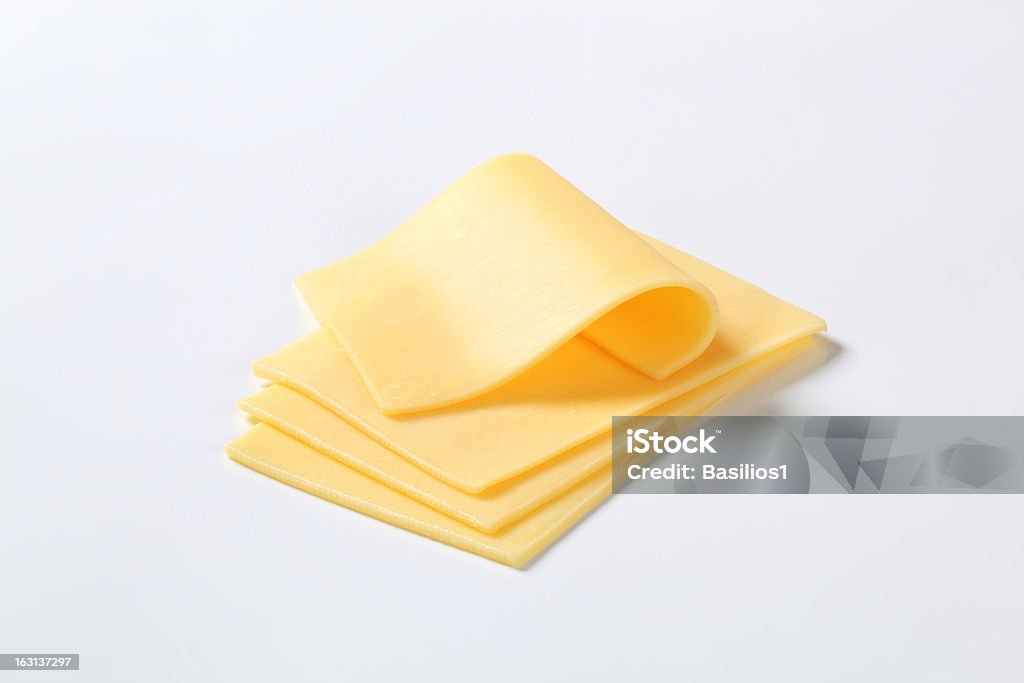 Four cut up slices of cheese isolated on a white background four thin slices of a fresh cheese Cheese Stock Photo